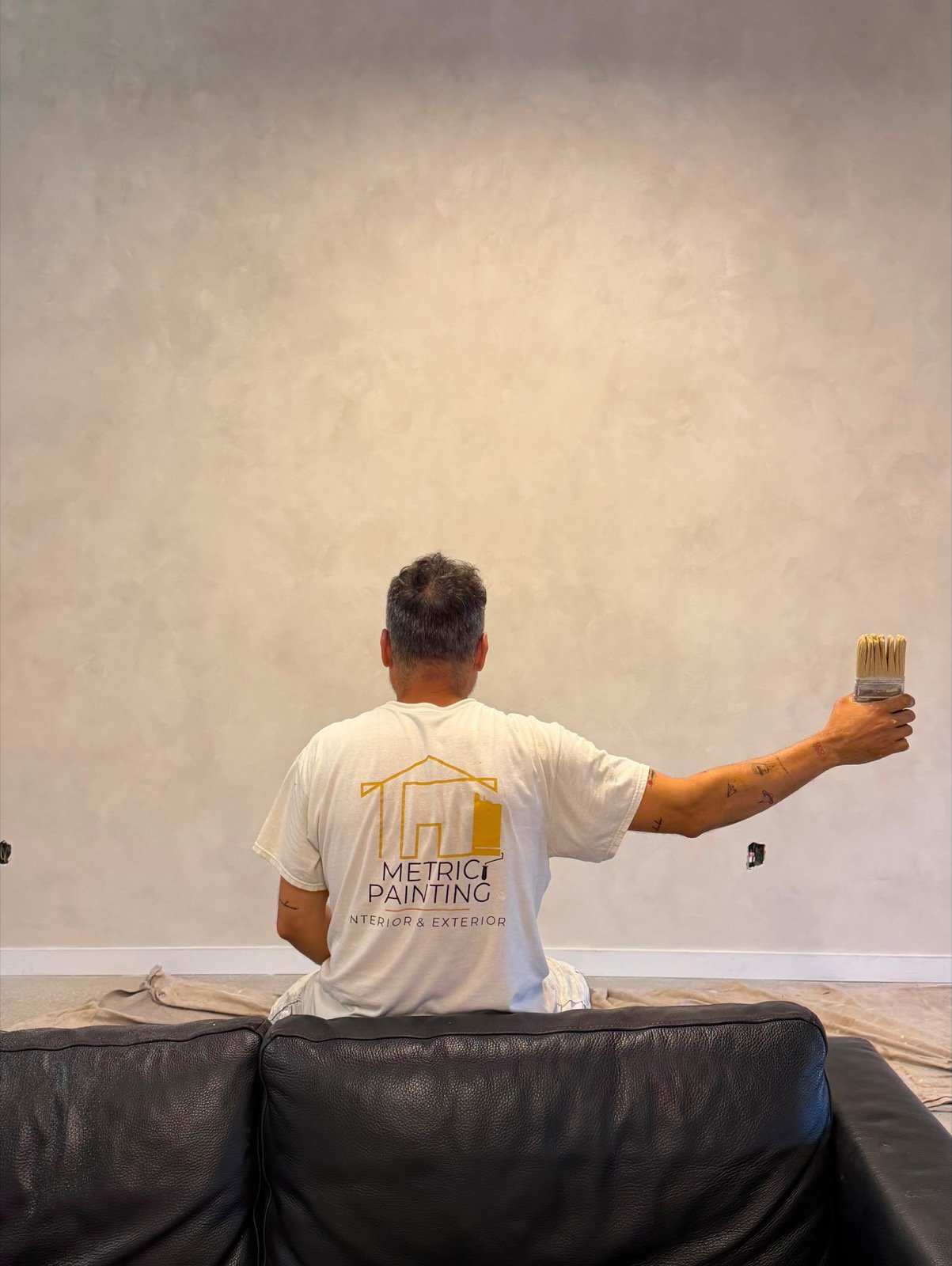 A Metric Painting crew member hand-finishing a limewash wall.